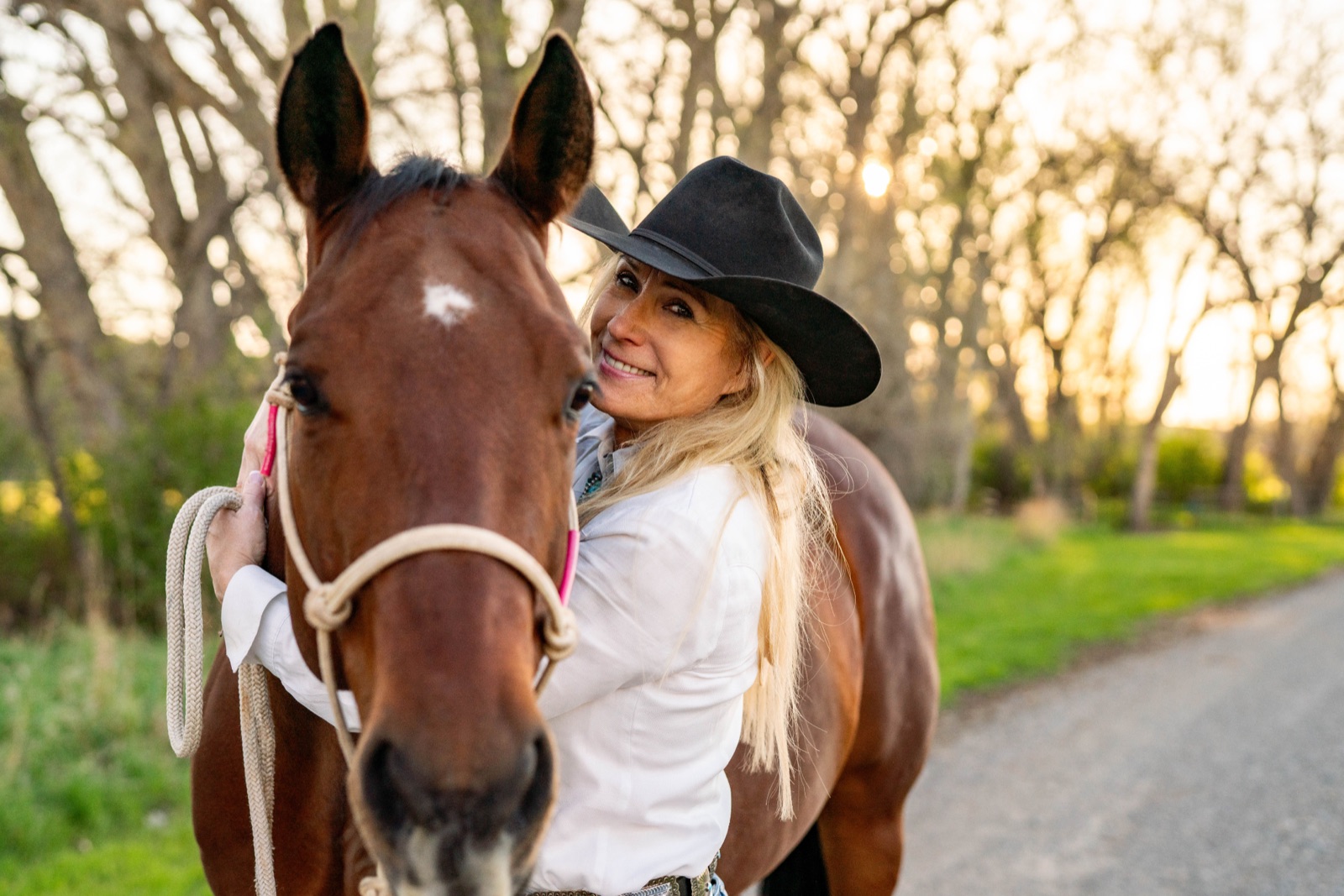 Jann Parker smiling beside a horse.