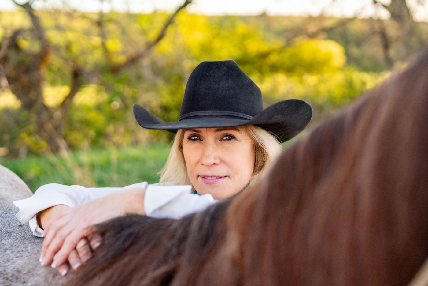 Portrait of Jann Parker with a horse.